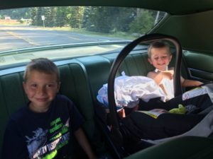 Maiden voyage home in the family’s 1977 Chrysler Newport two-door hardtop, with big brothers Max and Cole.